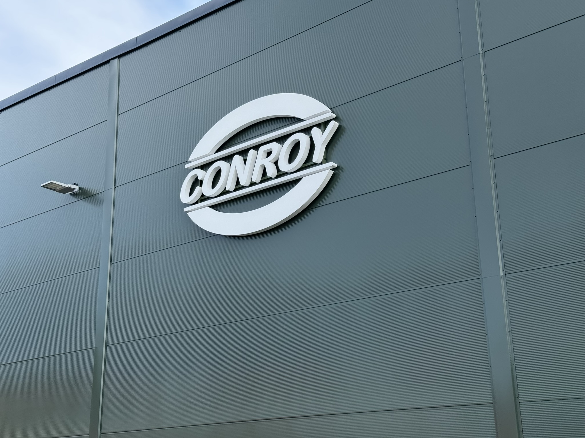 A sign depicting the logo of Conroy Medical on the side of a building